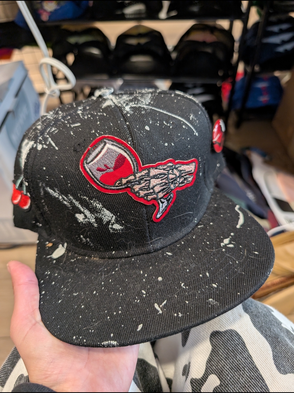 Black Paint-Splatter Snapback Hat with Red Skull Logo